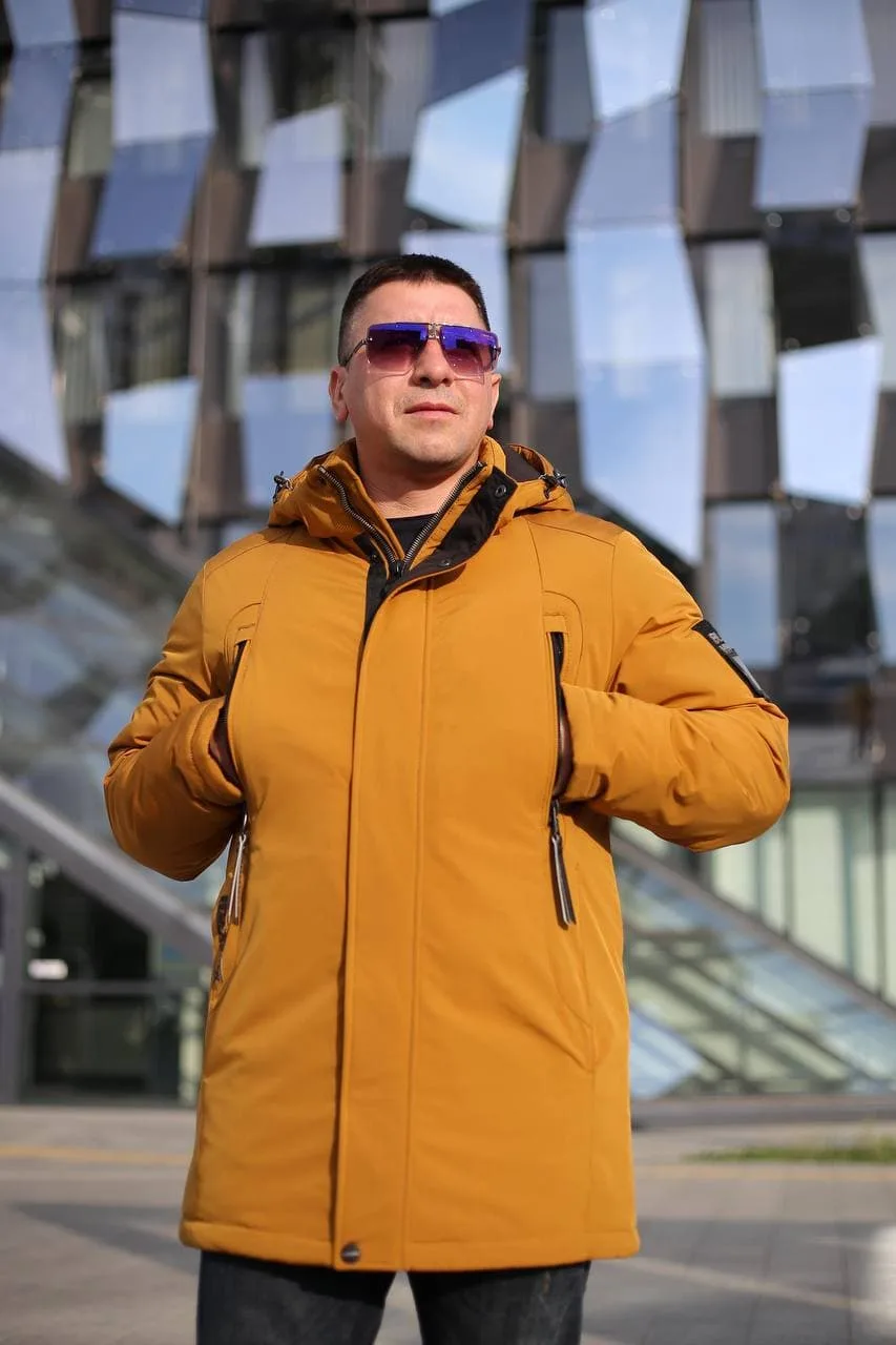 Модель с руками в верхних карманах зимней куртки